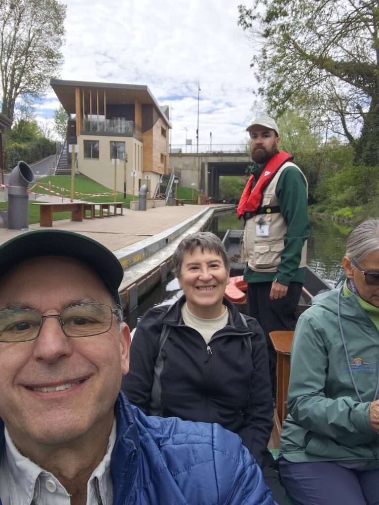 Selfie on a small boat going through a canal lock with Ben and Kathy and a guide in a red life vest