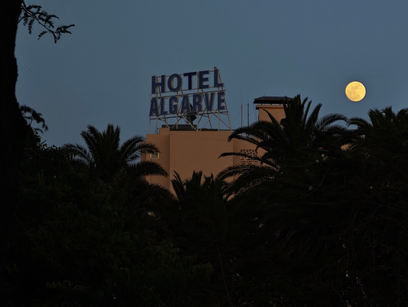 Hotel Algarve sign with full moon rising at dusk