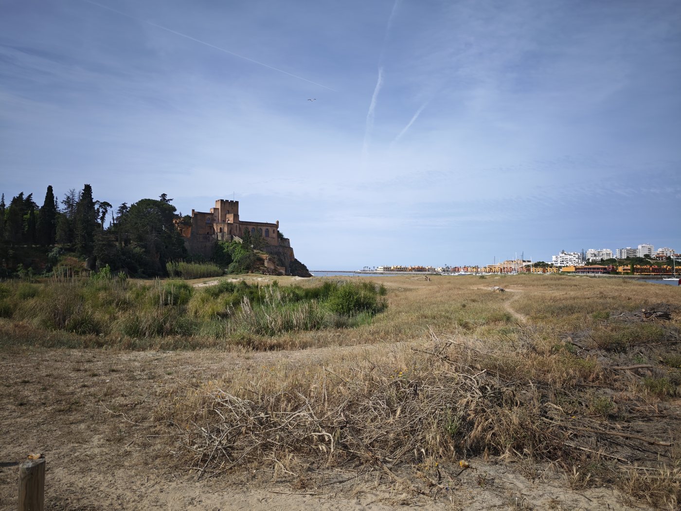 Medieval Ferragudo castle across the estuary at low tide