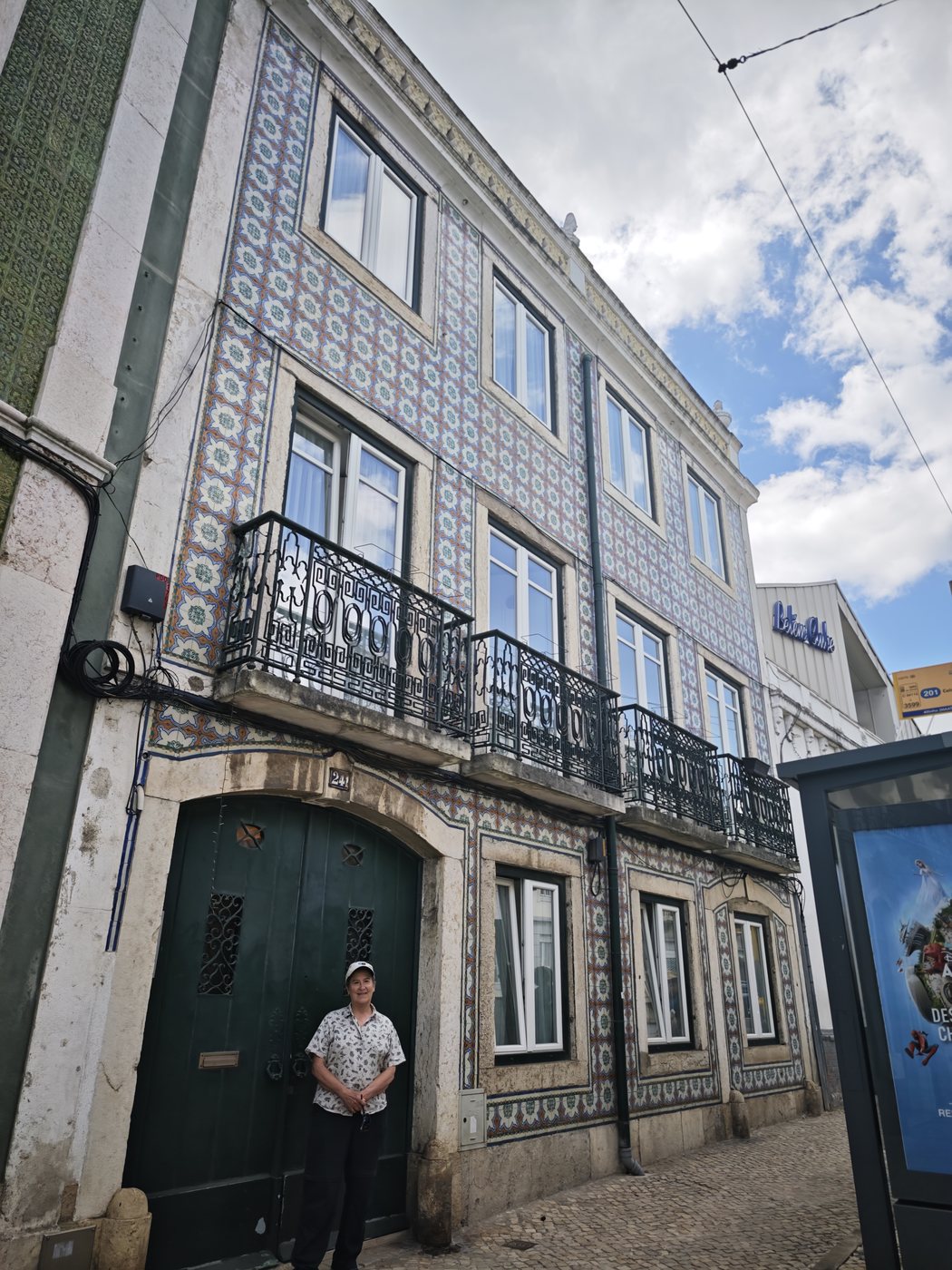 Ben posing in front of a traditional Lisbon tiled building facade