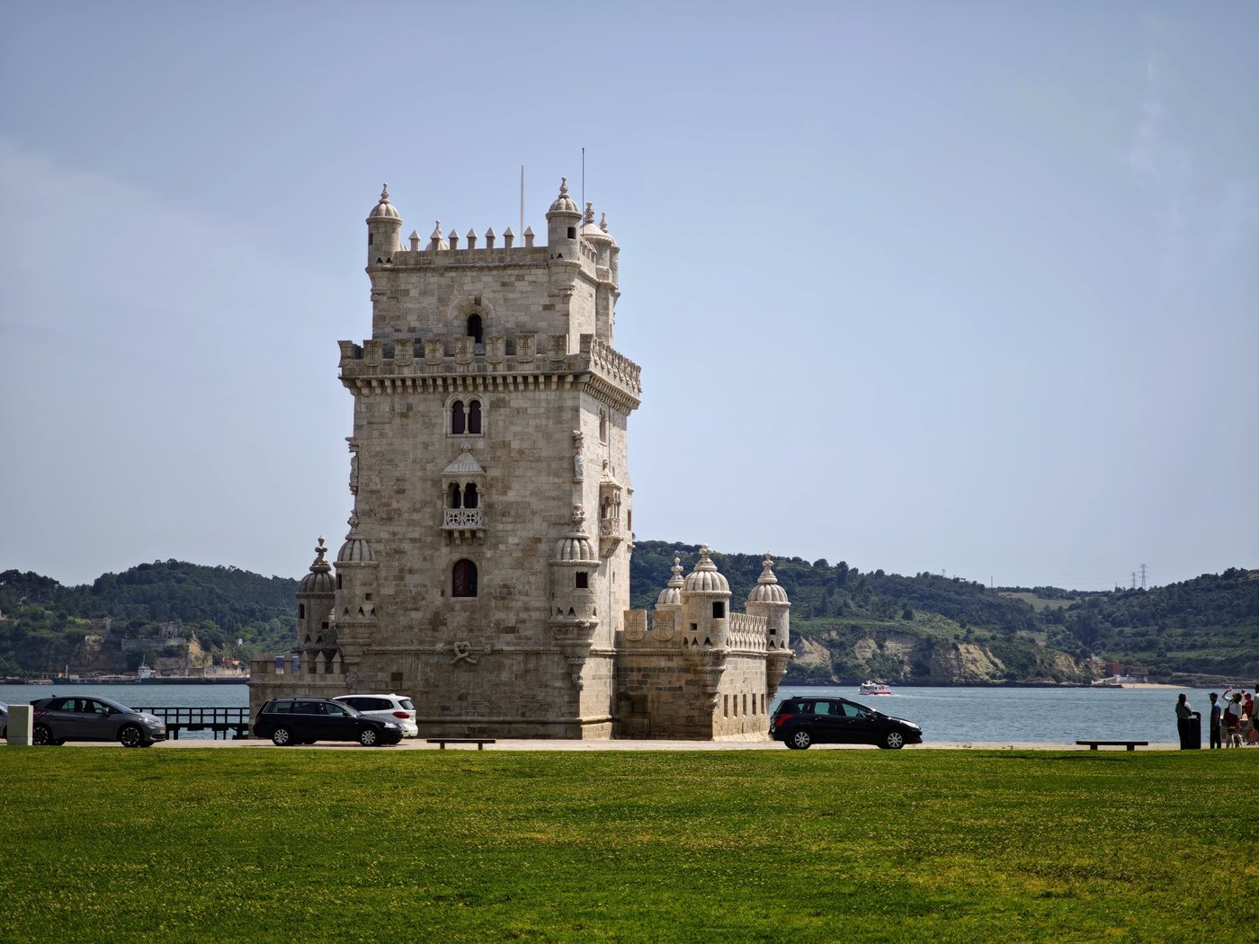 Belém Tower standing alone on the Tagus riverbank on a clear day