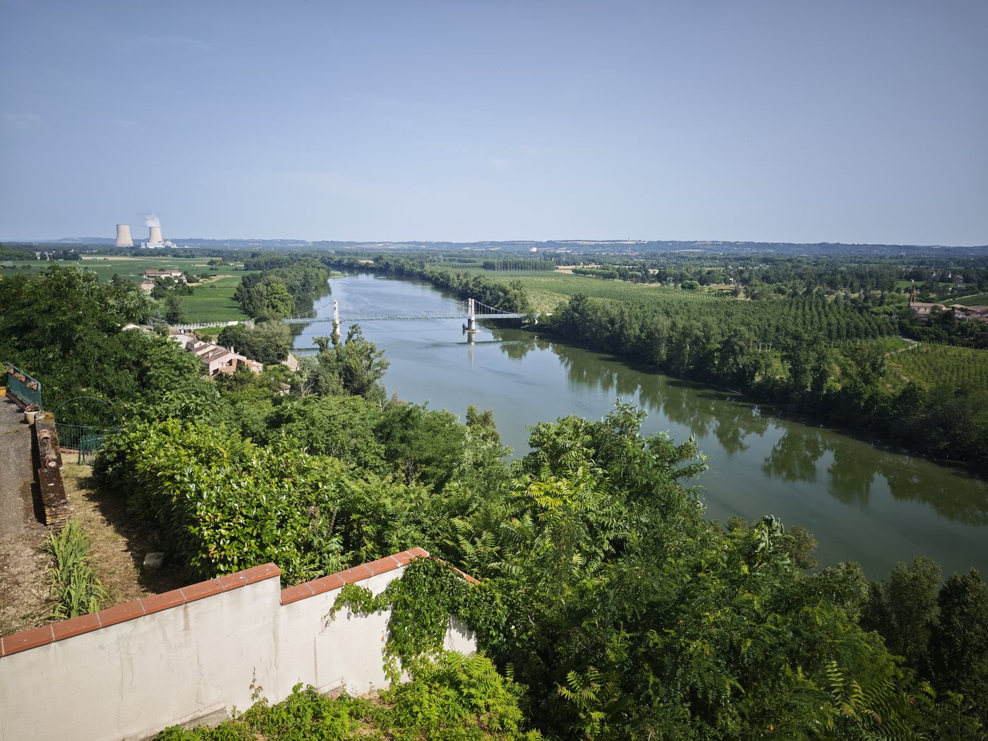 View of the Garonne river from Auvillar with the Golfech nuclear plant cooling towers on the horizon