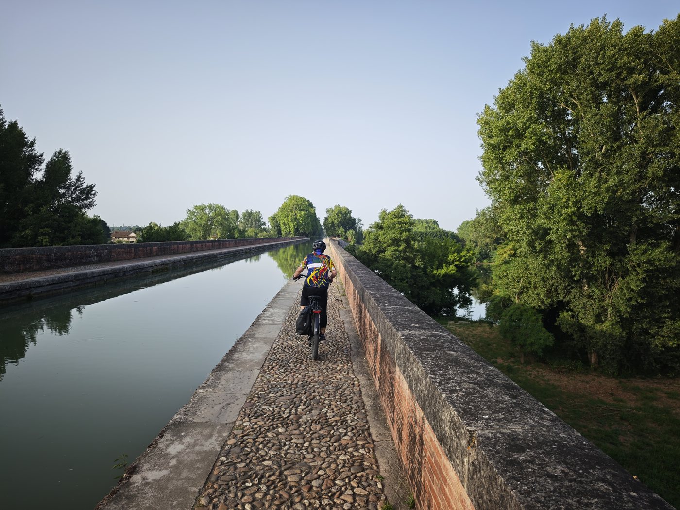 Cycling along the top of the Pont-Canal d'Agen, the aqueduct carrying the canal over the Garonne river